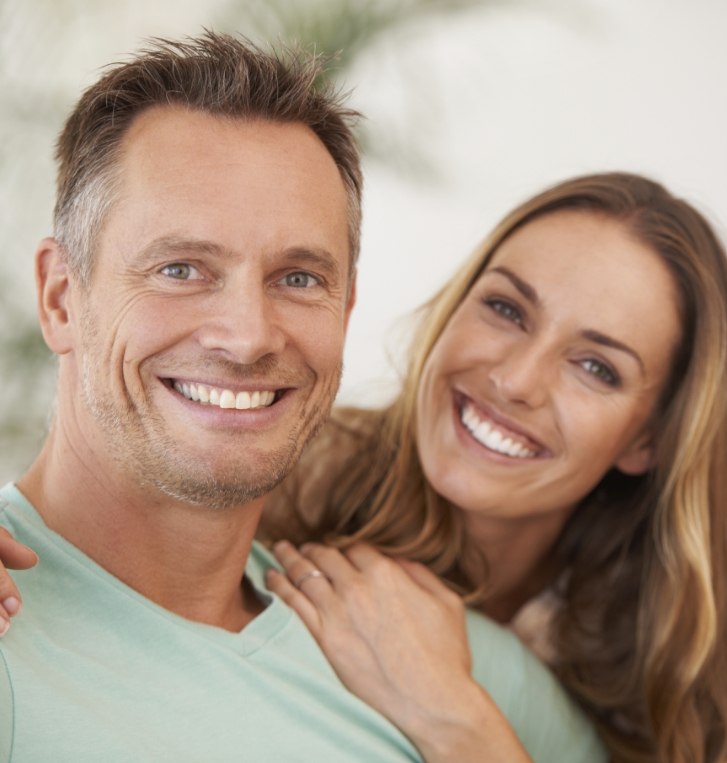 Man and woman smiling together on couch