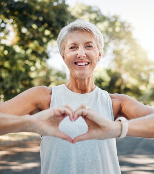 Lady makes shape of heart with her hands