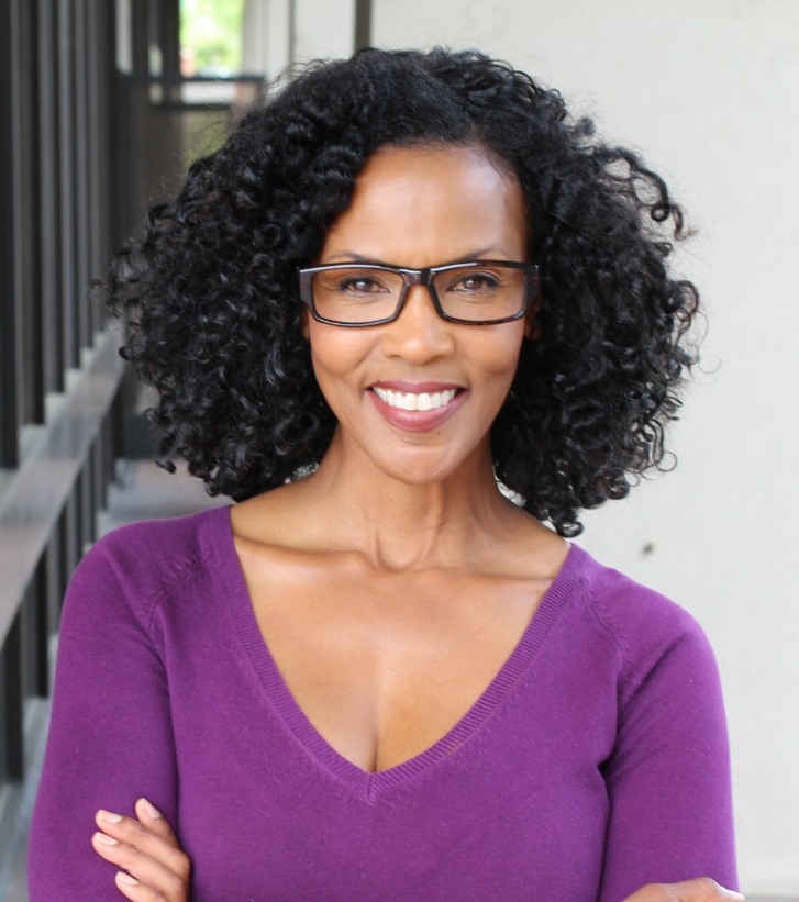 Smiling woman in purple blouse