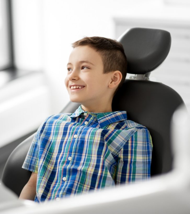 Young boy smiling in dental chair