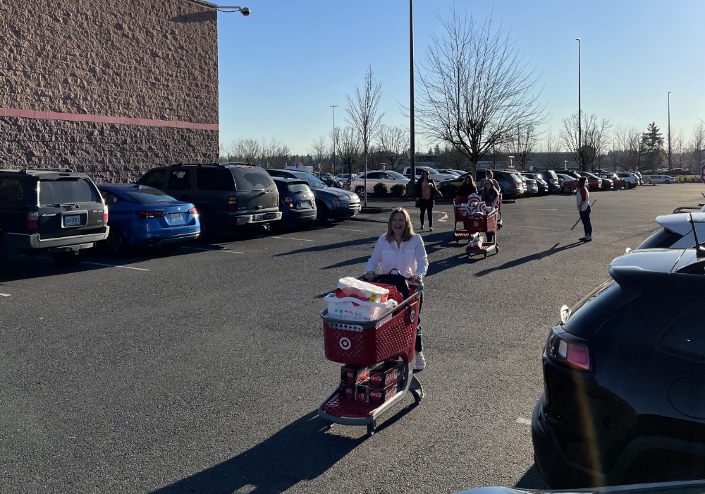 Dental team members in parking lot with Target shopping carts