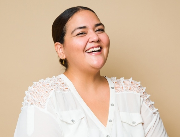 Woman in white blouse laughing