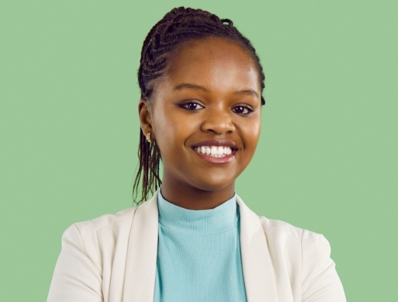 Woman smiling against light green background