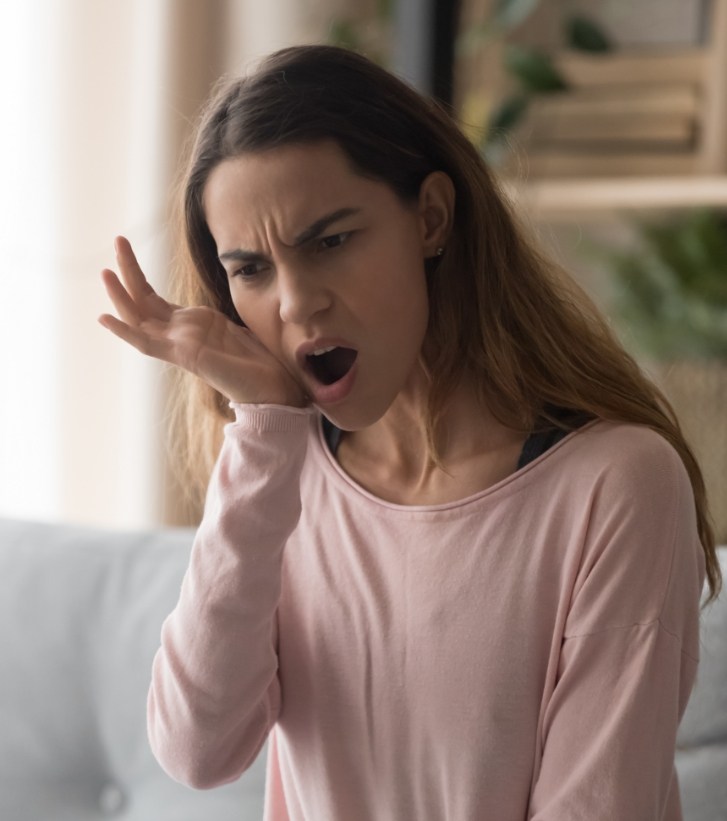 Woman holding her jaw in pain