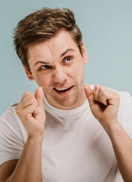 Man flossing his teeth