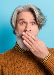 Senior man covering his mouth with his hand