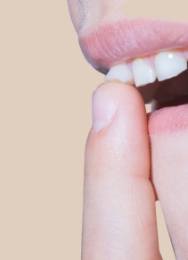 Close up of person wiggling their loose tooth