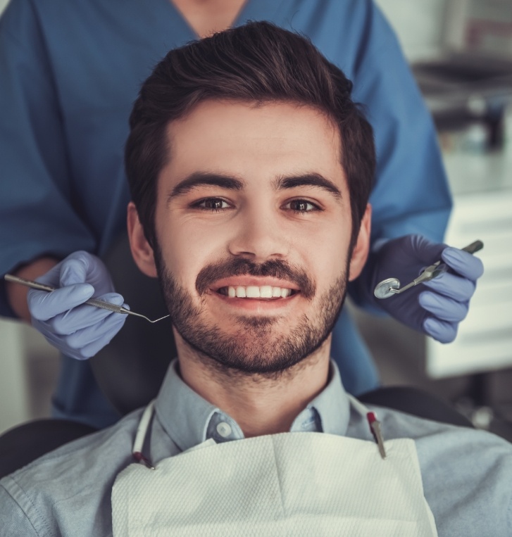 Man smiling in dental chair at Hillsboro dental office