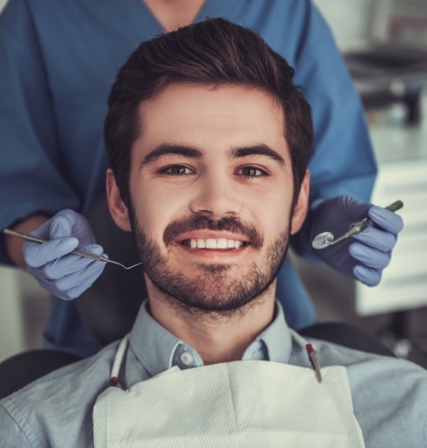 Man smiling in dental chair at Hillsboro dental office