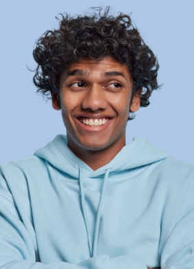 Man in blue hoodie smiling and looking to the right