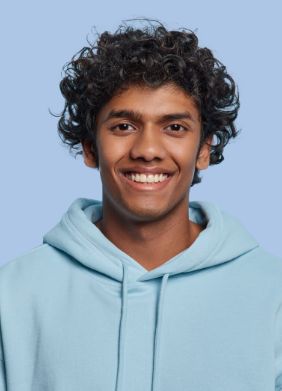 Man in blue hoodie smiling at the camera