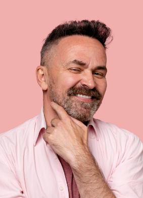 Man in pink shirt resting his hand under his chin