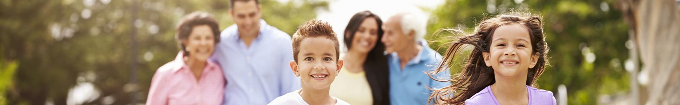 Three generations of smiling family outdoors