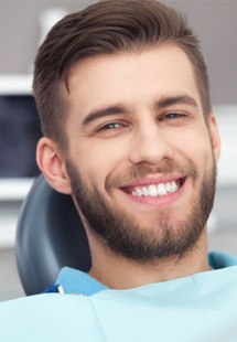 patient smiling in dental chair 