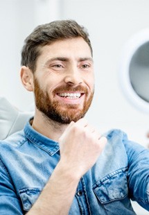 young man smiling in dental chair 