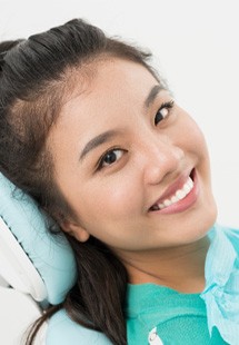young woman smiling in dental chair