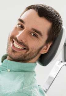 young man smiling in dental chair 