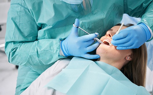 A sedated woman receiving dental treatment