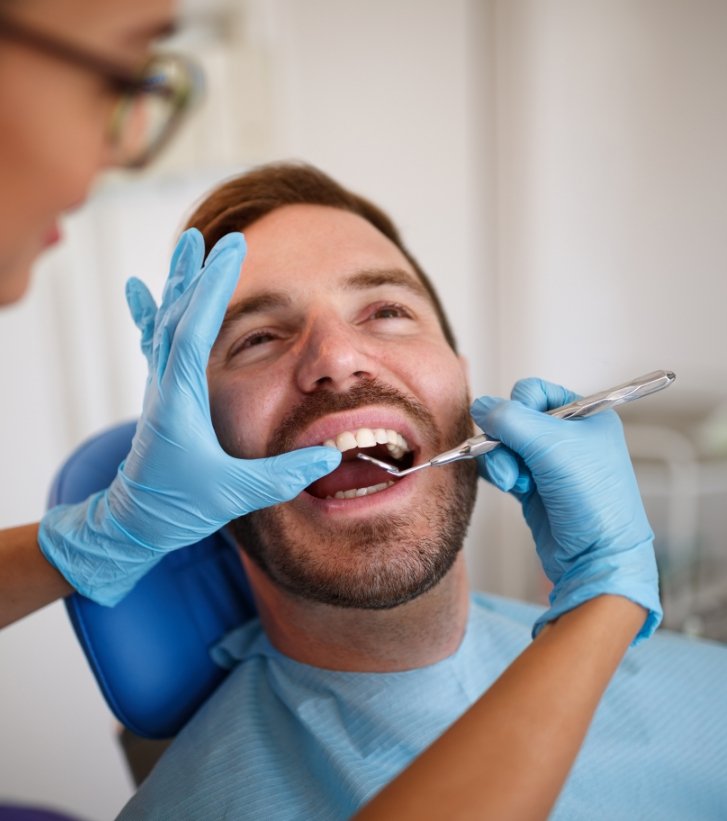 Dental team member performing dental checkup