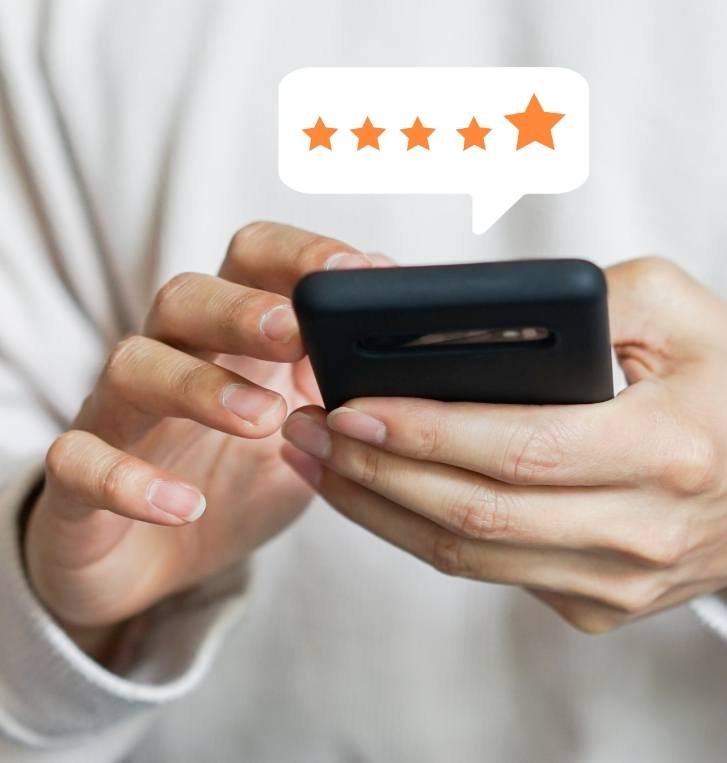 Person typing on phone with graphic showing five stars