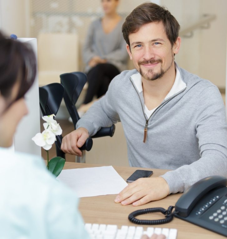 Man smiling while at smile makeover consultation