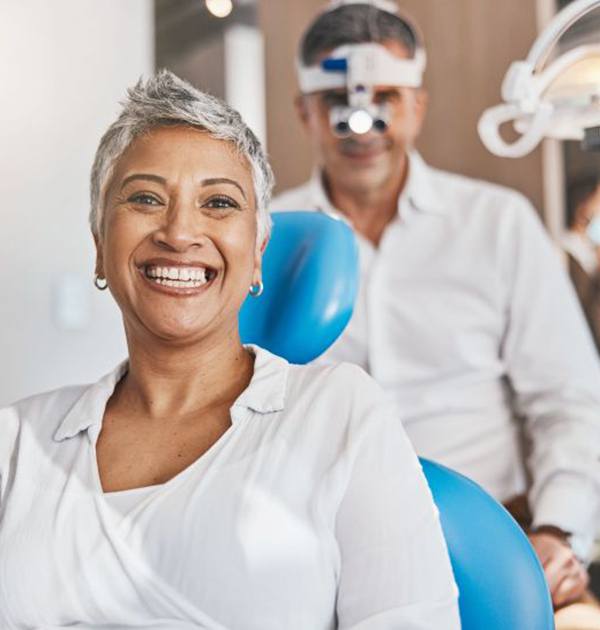 Happy gray-haired woman in dental treatment chair