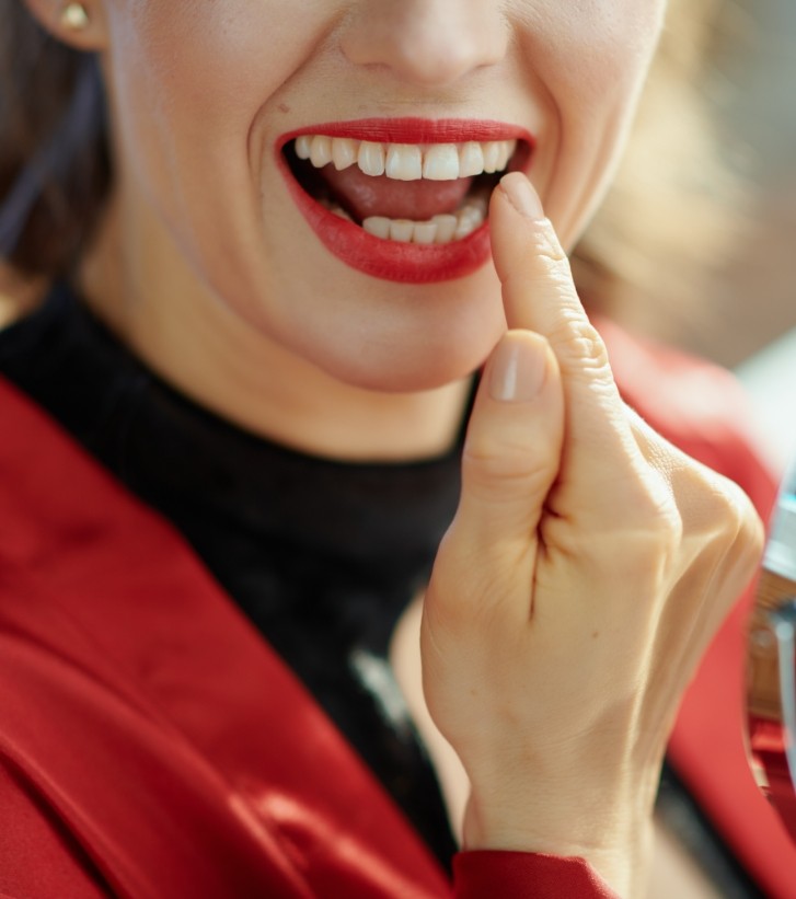 Woman looking at her mouth in a mirror