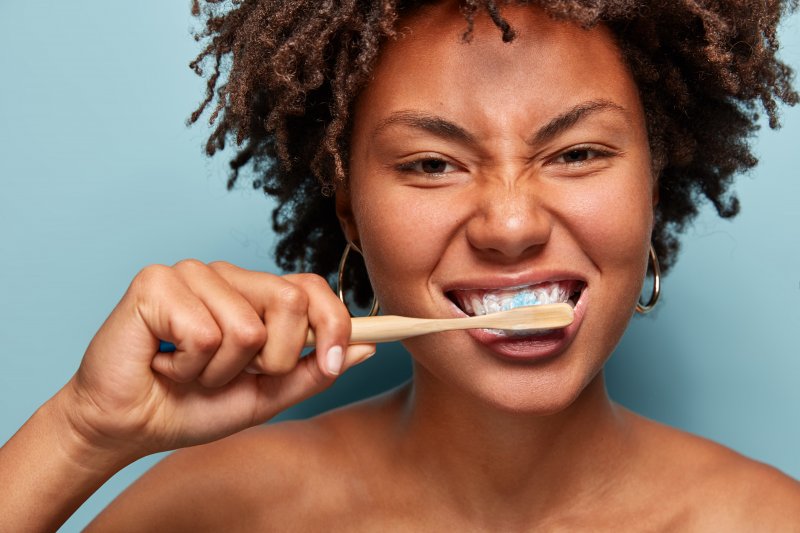 patient brushing teeth to prevent cavities during Invisalign in Hillsboro