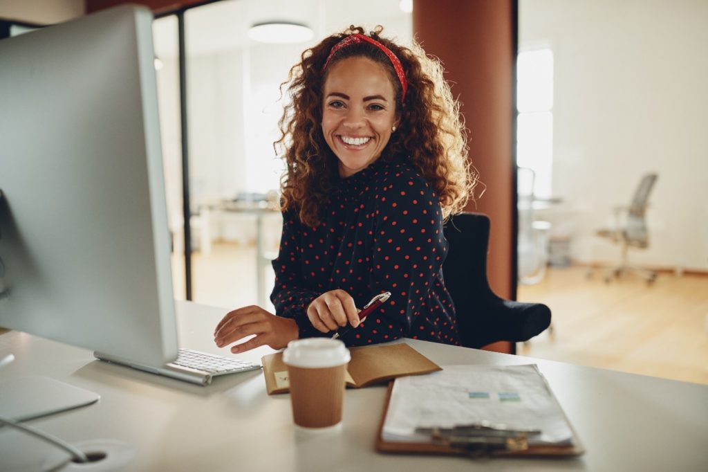 Young professional smiling while working at desk