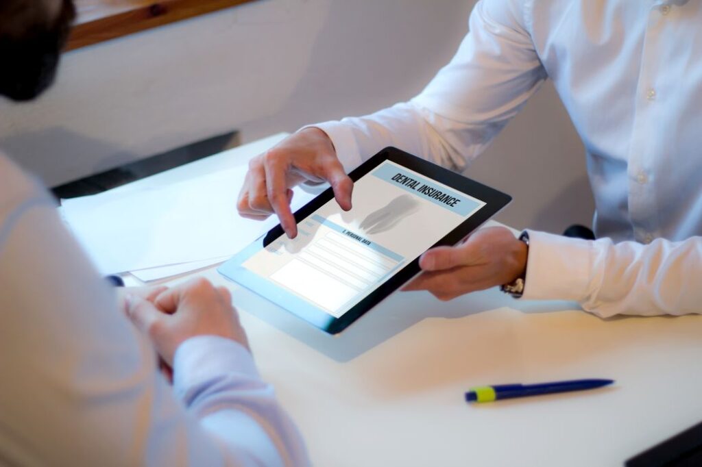A patient signing up for dental insurance.